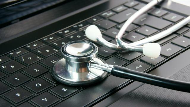 A stethoscope on top of a laptop.
