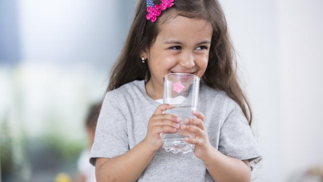 A child holds glass of water