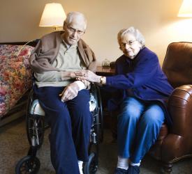Seated older couple looking at camera
