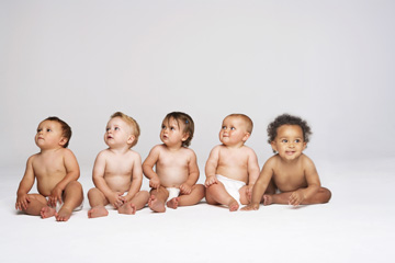 Five babies in diapers looking to the right except for the last baby looking the other way.