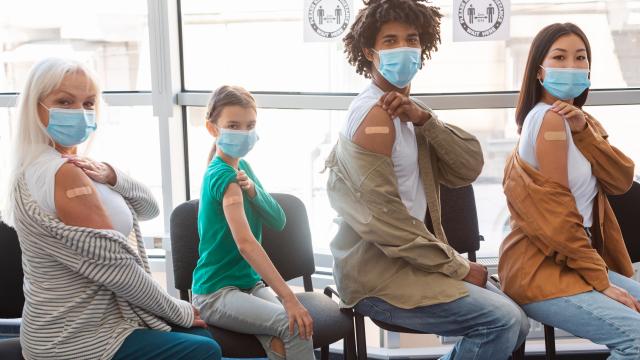 Four people showing their arm with band-aid after vaccination