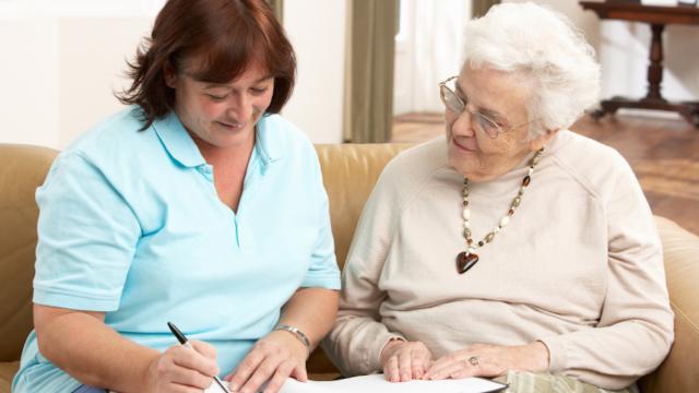 Two adults reviewing information in a binder at home