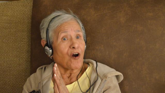 Rosario listens to music as part of Music and Memory program.