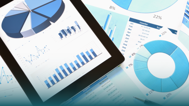 paper and tablet displaying charts