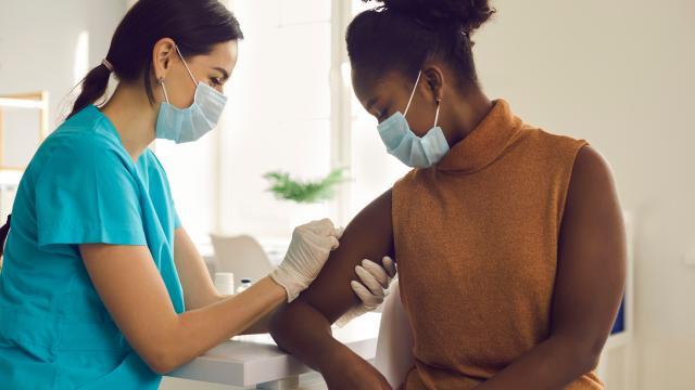 Medical staff vaccinating an adult