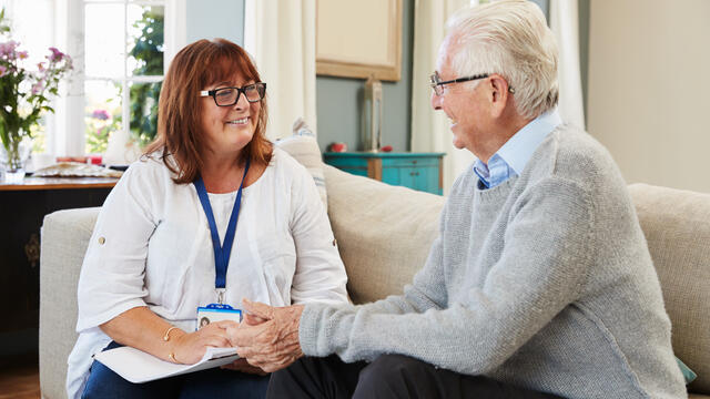 Professional doing an in-home visit with an adult