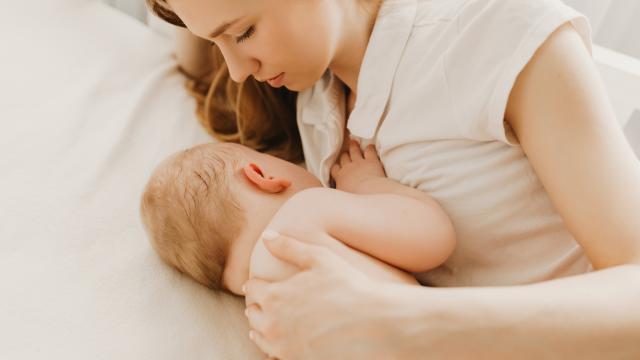 Adult breastfeeding a baby