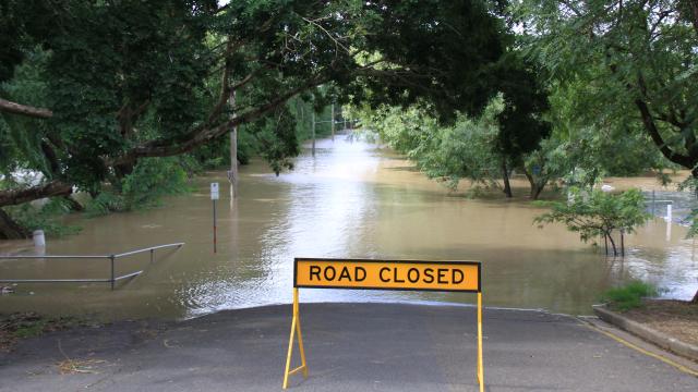 A sign, road closed, set on flooded road