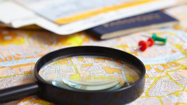 A magnifying glass over a map.