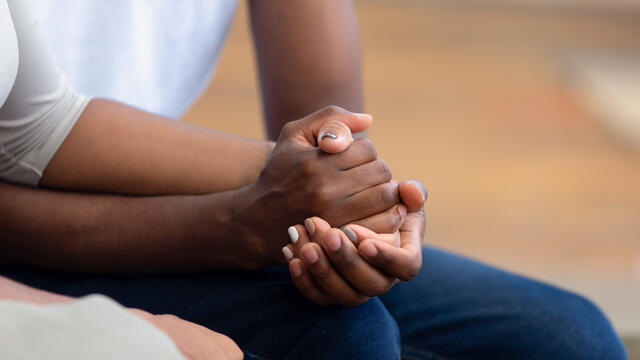 Close up of two people holding hands