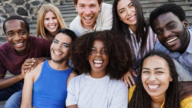 A group of eight young adults laughing