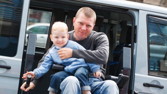 An adult and a child getting out of a van.