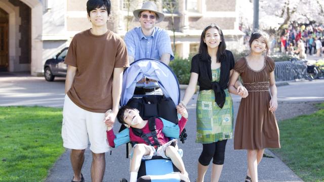 Family walk together outside on sidewalk