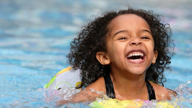 Happy child on the inner tube in the swimming pool
