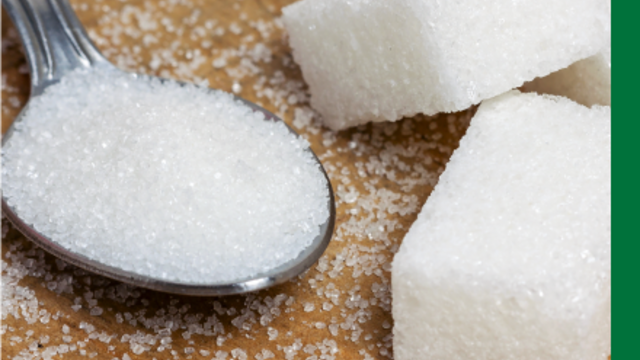 Spoon of sugar next to several sugar cubes