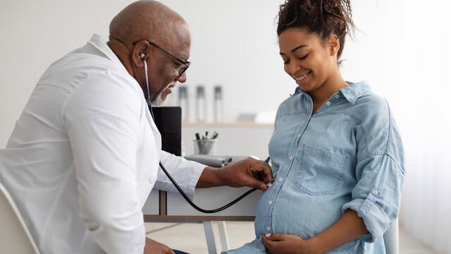 Pregnant person at prenatal visit with doctor