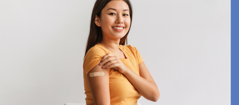 Adult showing a bandage on her arm after a vaccination