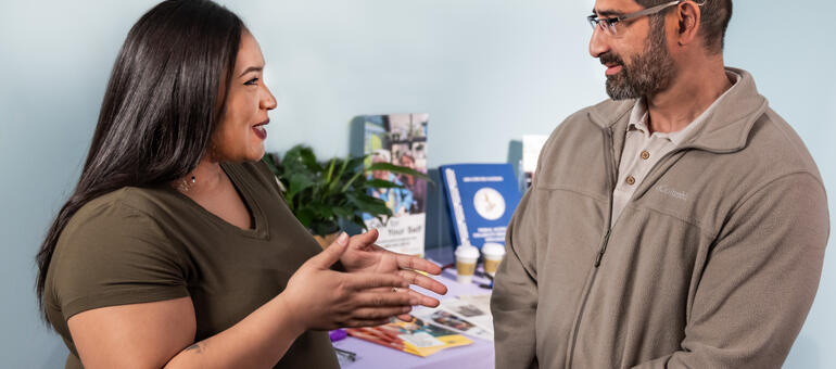 Information specialist sharing resources with adult customer