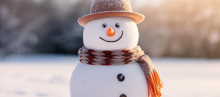 Close up of a happy snowman wearing a hat and scarf