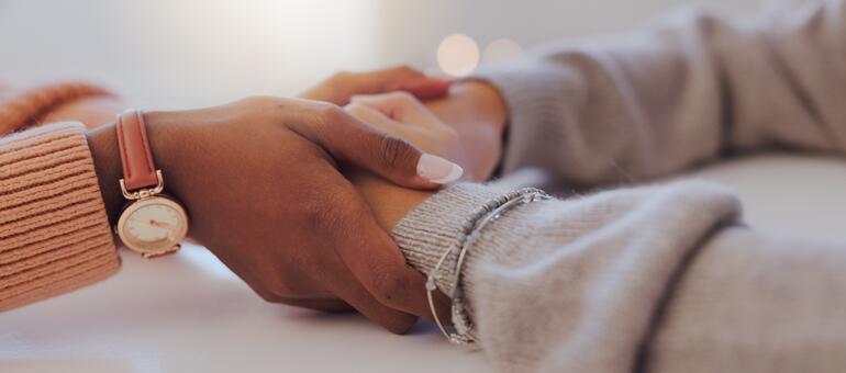 Hands hold hands of another person