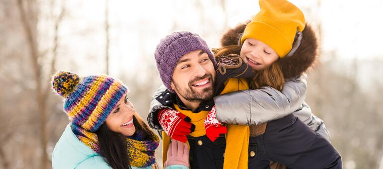 Parents and child ouside enjoying Winter
