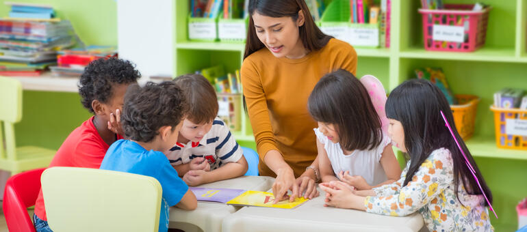 Adult teaching young children