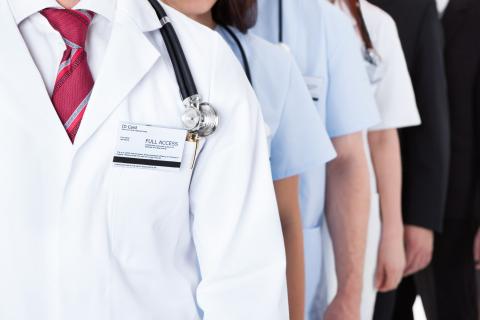 ID card on a white coat with stethoscope along with others as well as business suits.