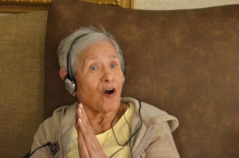 Rosario listens to music as part of Music and Memory program.