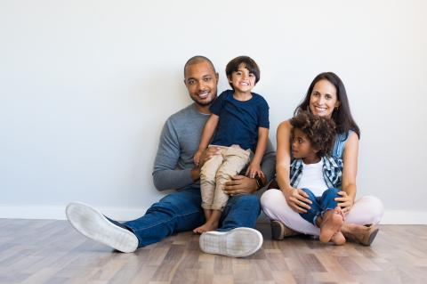 Family of four sitting on the floor