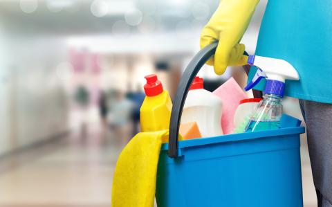 Bucket of cleaning products being carried