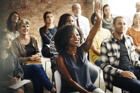 One adult raised hand in a seminar