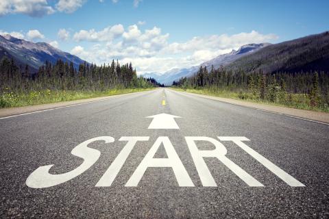 The word start with an arrow painted on a country road