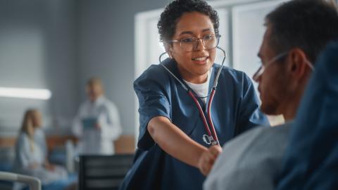 A medical professional listening to a patient's heart