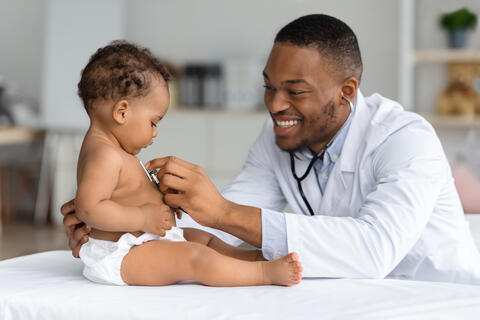 A doctor giving a baby a check up