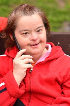 Person in red jacket talking on a cell phone