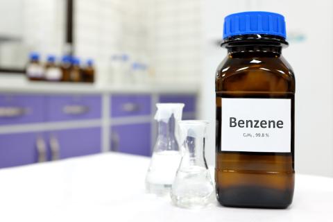 Brown bottle of benzene on a lab table