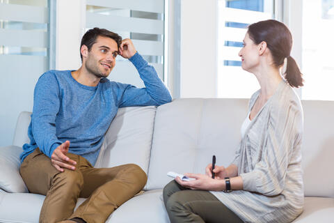 Adult on couch talking to a psychologist