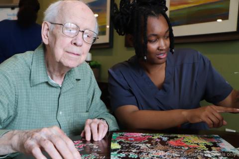 Capri Caregiver With Resident Doing a Puzzle