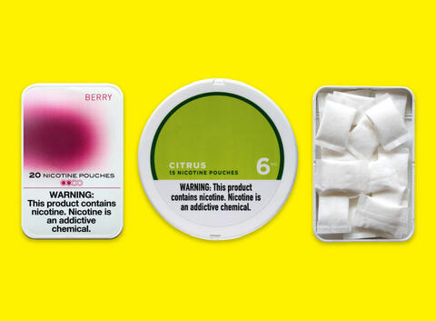 Collection of three oral nicotine products, including two flavored as Berry and Citrus and another tin filled with white pouches of nicotine.