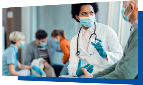 Medical professional wearing mask and gloves talking with an adult