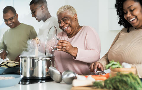 A family in the kitchen cooking dinner