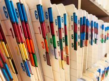 Color and number coded file folders in a cabinet