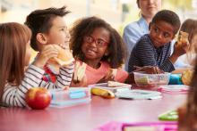 Group of children eating lunch at school