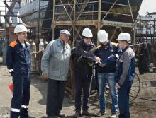 Engineers discuss plans at the shipyard