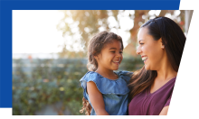 Laughing adult holding a laughing child