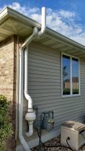 Radon mitigation system outside of a house.