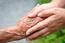 Young pair of hands holding an older pair of hands