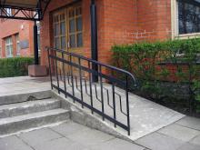 A ramp next to steps at a building.