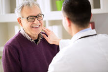 Doctor talking to a smiling older adult