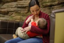 Mom sitting while breastfeeding her child